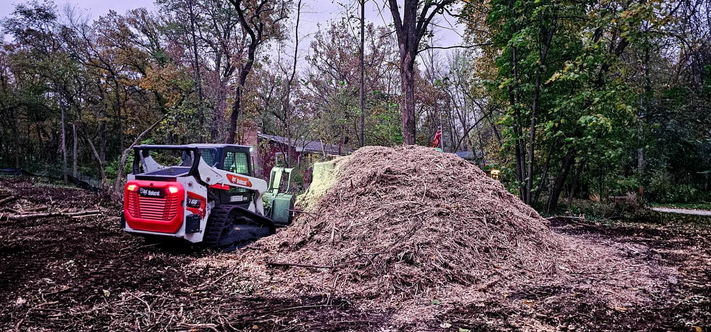 Bobcat with mulch pile